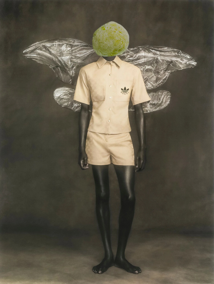 model wearing gucci adidas yellow polo and shorts with silver prop wings